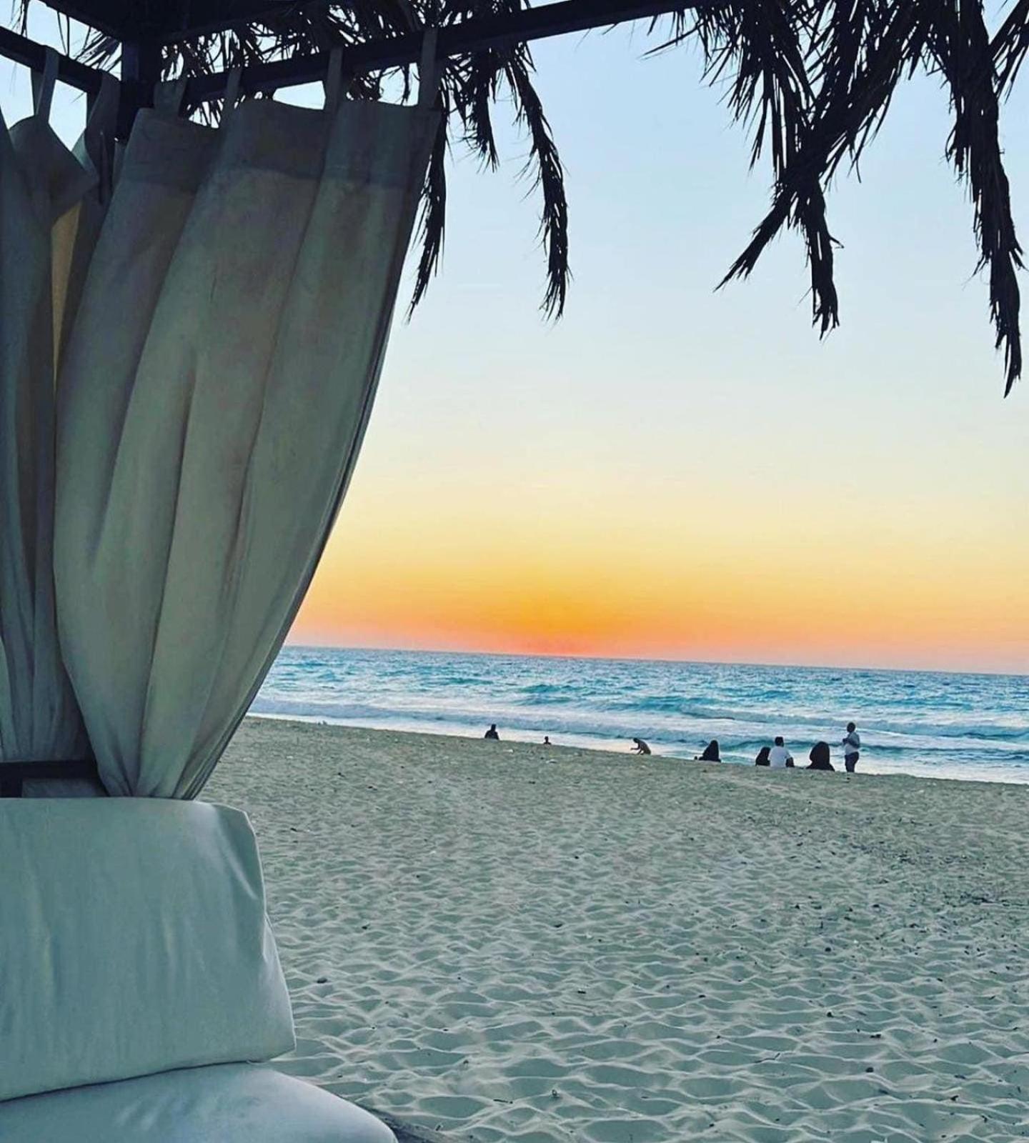 Borg El Arab Beach Resort Exterior photo Sunset at the beach