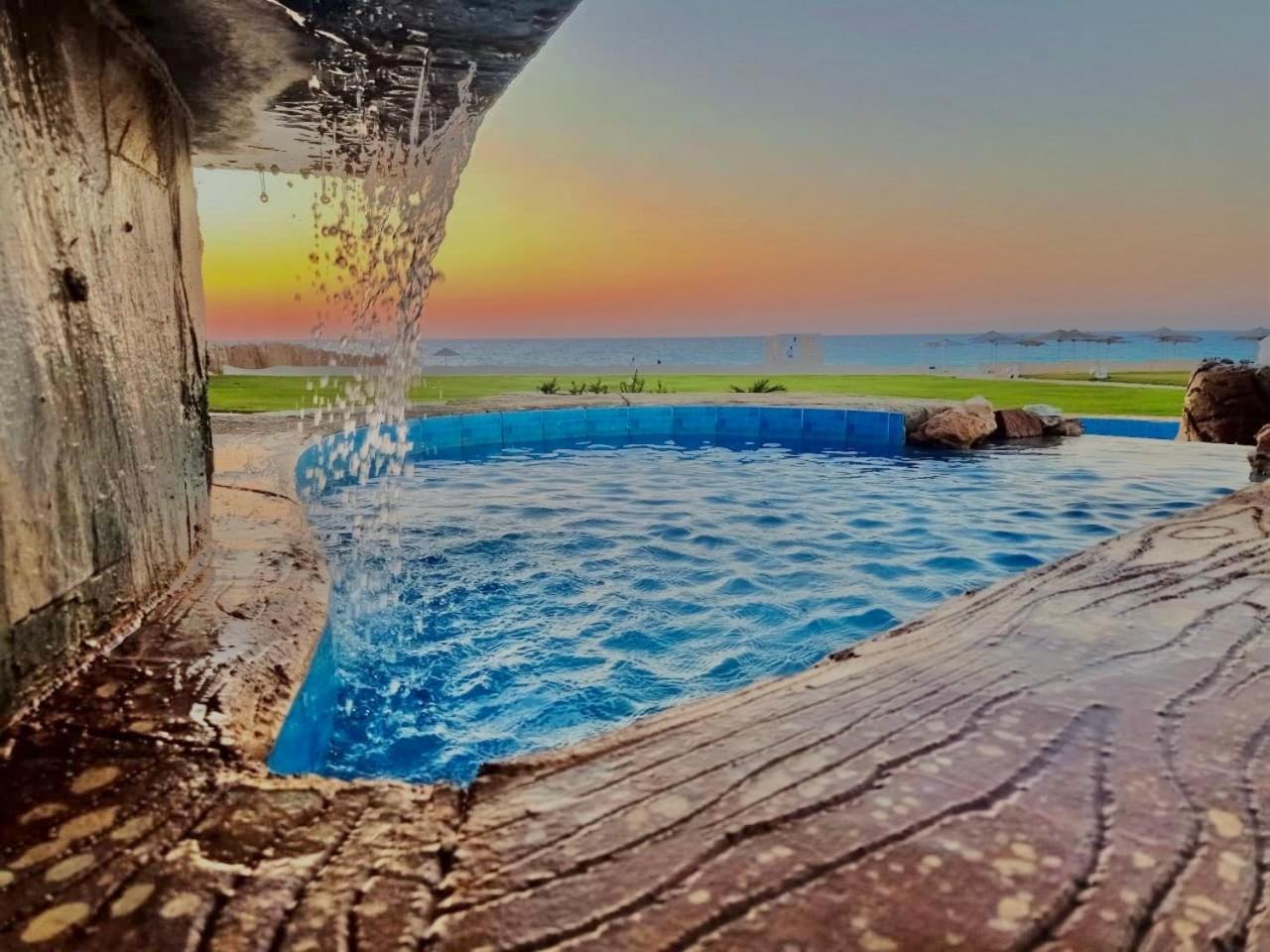 Borg El Arab Beach Resort Exterior photo Sunset at the beach