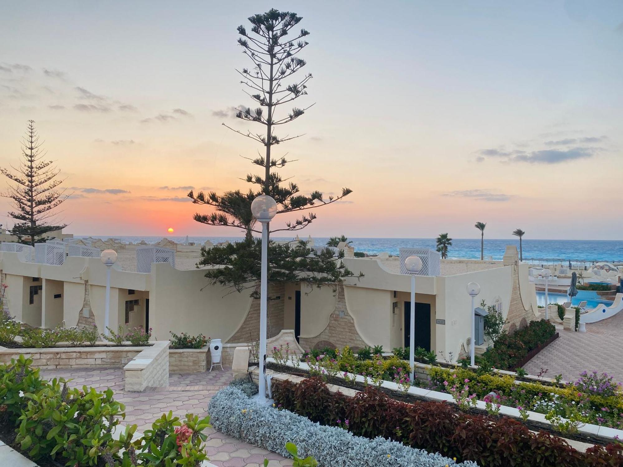 Borg El Arab Beach Resort Exterior photo Sunset at the hotel