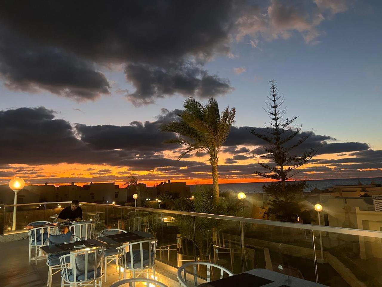 Borg El Arab Beach Resort Exterior photo Sunset at the beach